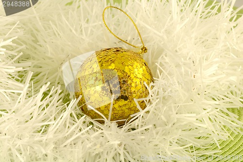 Image of white christmas decoratrion with yellow ball, new year decoration