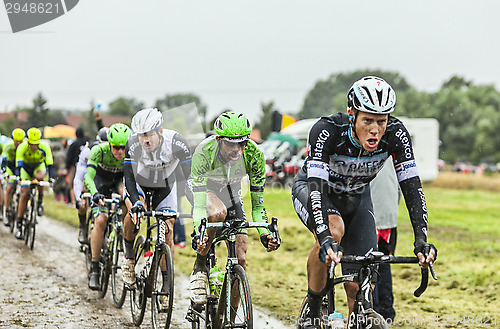 Image of The Peloton on a Cobbled Road- Tour de France 2014