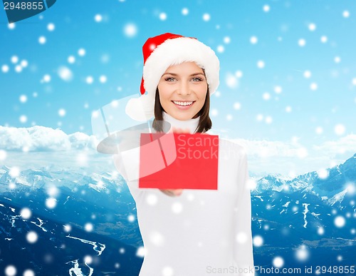 Image of woman in santa helper hat with blank red card