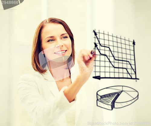 Image of businesswoman drawing charts in the air