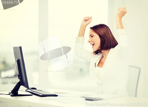 Image of businesswoman with computer in office