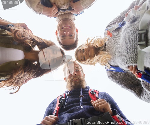 Image of group of smiling friends with backpacks hiking