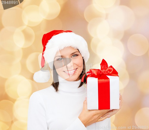 Image of smiling woman in santa helper hat with gift box