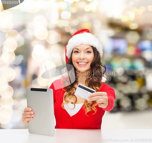 Image of woman in santa hat with tablet pc and credit card