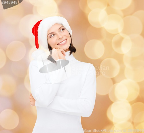 Image of thinking and smiling woman in santa helper hat