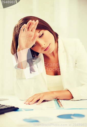 Image of bored and tired woman with documents