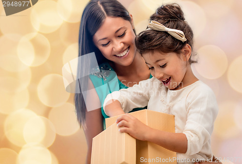 Image of happy mother and child girl with gift box