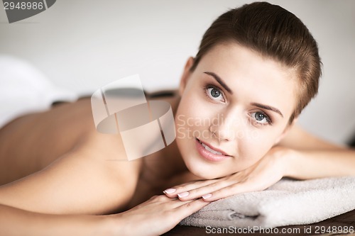 Image of woman in spa salon with hot stones