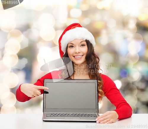 Image of smiling woman in santa helper hat with laptop