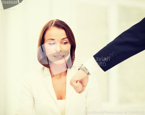 Image of boss showing time to stressed businesswoman