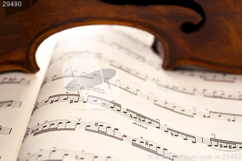 Image of Light through violin's ribs on music score