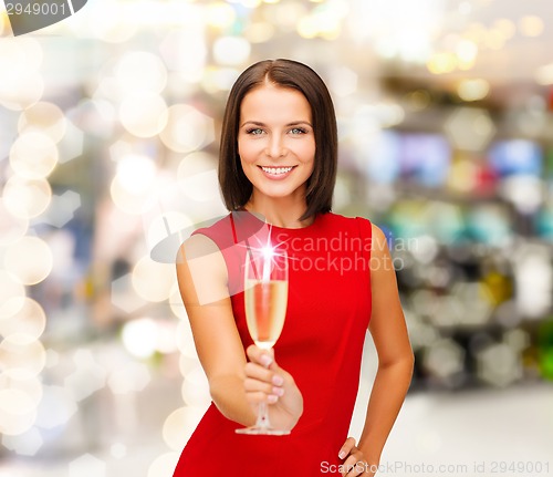 Image of smiling woman holding glass of sparkling wine