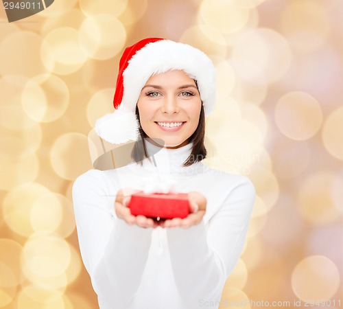 Image of smiling woman in santa helper hat with gift box