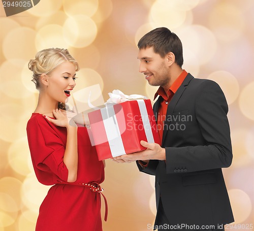 Image of smiling man and woman with present