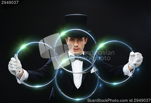 Image of magician showing trick with linking rings