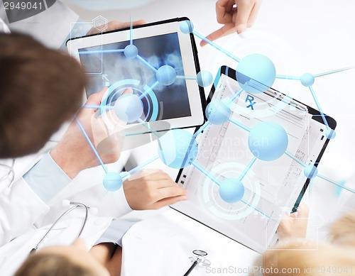 Image of group of doctors with tablet pc and clipboard