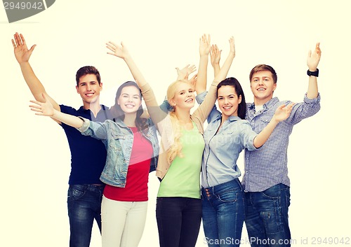 Image of group of smiling students waving hands