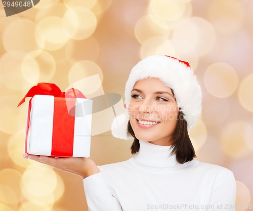 Image of smiling woman in santa helper hat with gift box