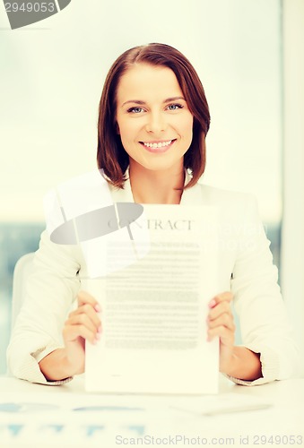 Image of happy businesswoman holding contract