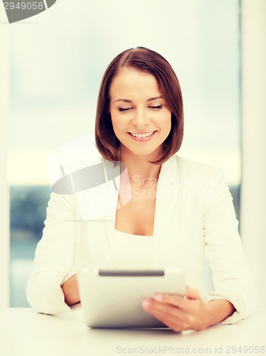 Image of businesswoman with tablet pc in office