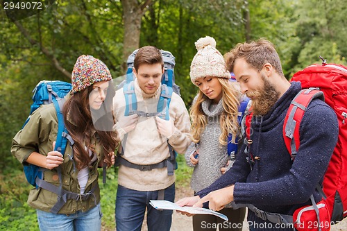 Image of group of smiling friends with backpacks hiking