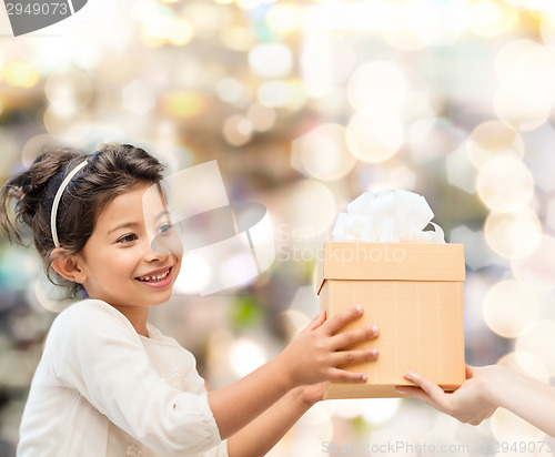 Image of smiling little girl with gift box