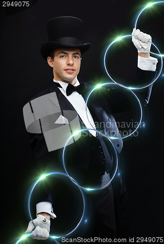 Image of magician showing trick with linking rings