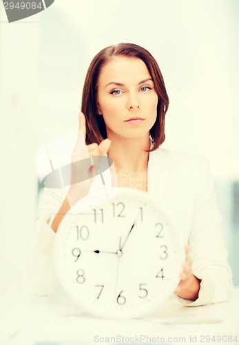 Image of attractive businesswoman with white clock