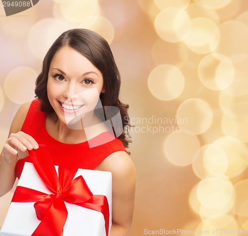 Image of smiling woman in red dress with gift box