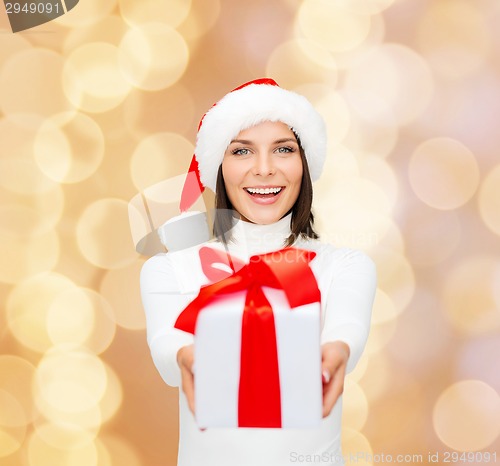 Image of smiling woman in santa helper hat with gift box
