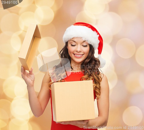 Image of smiling woman in santa helper hat with gift box