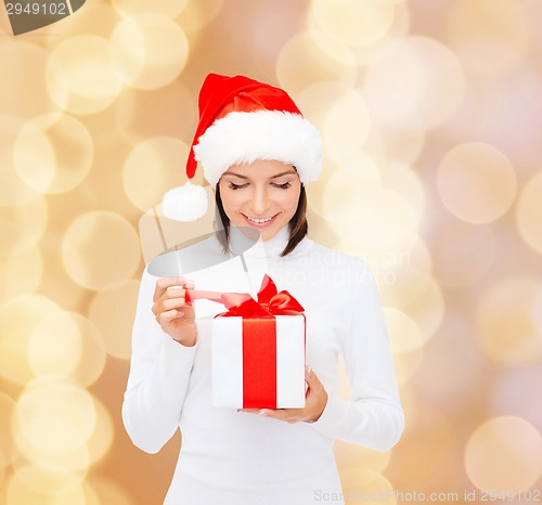 Image of smiling woman in santa helper hat with gift box