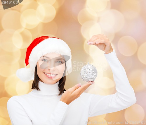 Image of woman in santa helper hat with christmas ball