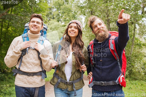 Image of group of smiling friends with backpacks hiking