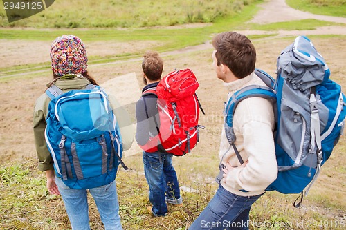 Image of group of smiling friends with backpacks hiking