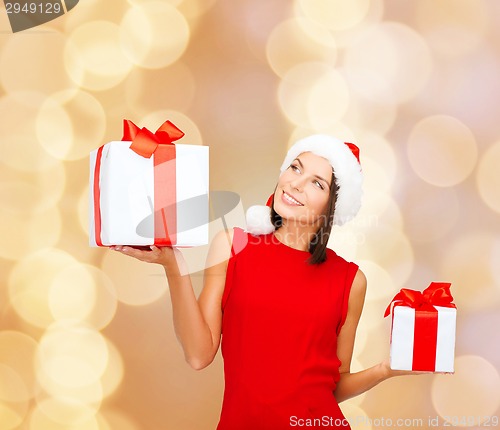 Image of smiling woman in red dress with gift box