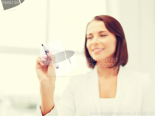 Image of businesswoman writing something in the air