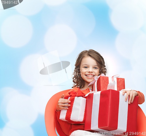 Image of smiling little girl with gift boxes