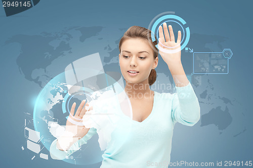 Image of smiling businesswoman working with virtual screen