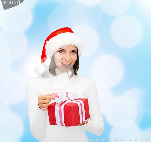 Image of smiling woman in santa helper hat with gift box