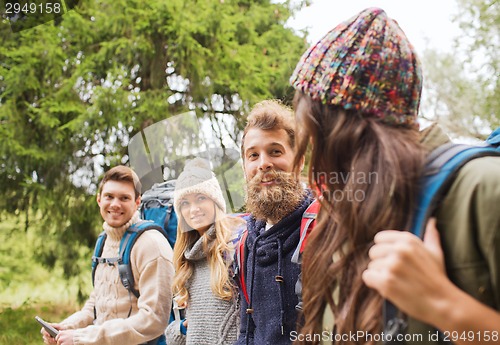 Image of group of friends with backpacks and tablet pc