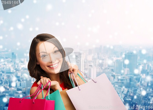 Image of smiling young woman with shopping bags