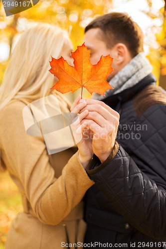 Image of close up of couple kissing in autumn park