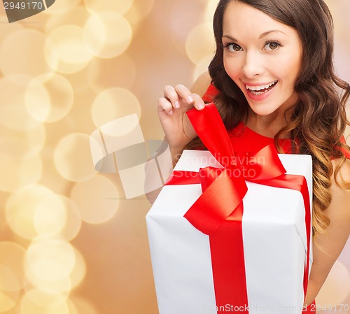 Image of smiling woman in red dress with gift box