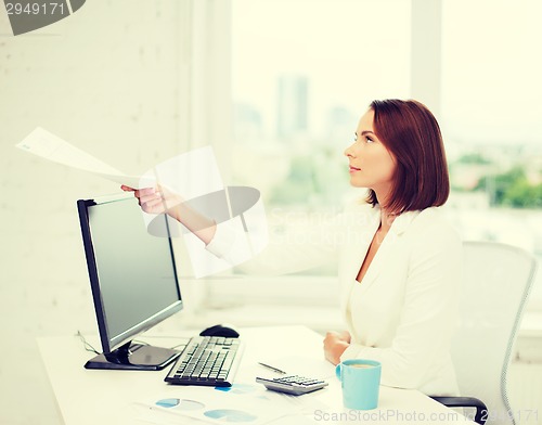 Image of businesswoman giving papers in office