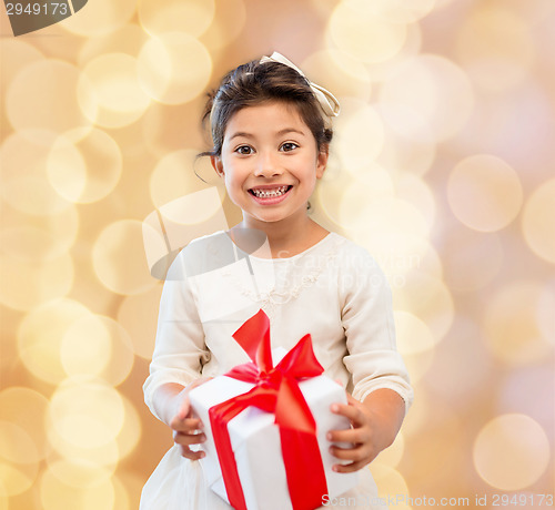 Image of smiling little girl with gift box