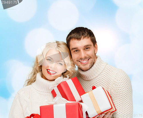 Image of smiling man and woman with presents