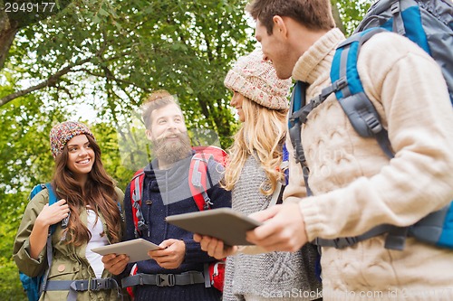 Image of group of friends with backpacks and tablet pc