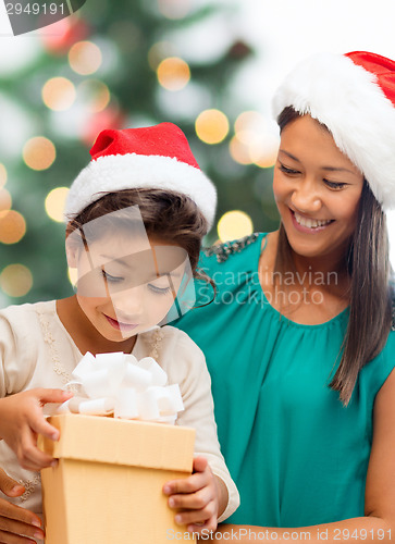 Image of happy mother and child girl with gift box