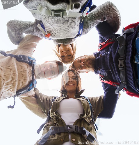 Image of group of smiling friends with backpacks hiking